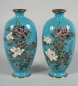 A PAIR OF JAPANESE BLUE GROUND CLOISONNE VASES, finely decorated with flora, 15.5cm high.