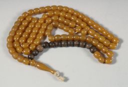 AN AMBER BEADED NECKLACE, each bead approx. 8mm wide, necklace with a section of wood beads.