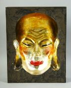 A CHINESE LACQUERED CONCAVE PICTURE OF A FACE, signed to reverse, 31cm x 24cm.