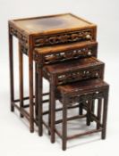 A GOOD NEST OF FOUR CHINESE HARDWOOD RECTANGULAR TABLES, with faux bamboo carved frames, fruiting