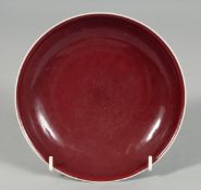 A CHINESE RED GLAZE PORCELAIN DISH, the base with incised six-character mark, 17cm diameter.