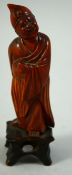 A CHINESE CARVED WOOD FIGURE, 12.5cm high.