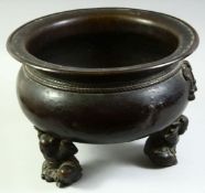A VERY LARGE CHINESE BRONZE TRIPOD CENSER, the feet formed as crouching figures holding the censer