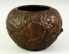 A SMALL CHINESE BRONZE BOWL with raised decoration depicting two dragons, with traces of gilt and