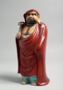 A JAPANESE KUTANI PORCELAIN FIGURE, of a bearded man holding a sceptre, 22cm high.