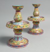 A PAIR OF CHINESE FAMILLE JAUNE PORCELAIN CANDLESTICKS, each with detachable tops, the inner rims