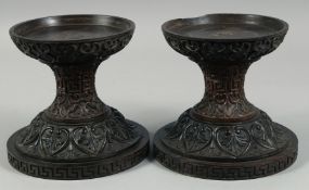 A PAIR OF 19TH CENTURY ANGLO INDIAN CARVED HARDWOOD PEDESTAL STANDS, 17.5cm high.