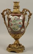 A LARGE CHINESE FAMILLE ROSE PORCELAIN URN WITH ORMOLU MOUNTS, the body painted with panels of