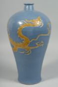 A CHINESE POWDER-BLUE GLAZE PORCELAIN MEIPING VASE, the body with carved dragon in yellow. 34.5cm