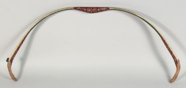 A TURKISH OTTOMAN WOODEN BOW, painted with foliate decoration and gilt highlights. 80cm long