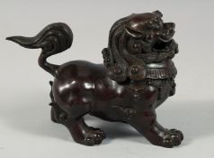 A CHINESE BRONZE LION DOG LIDDED CENSER, the detachable head as a cover, 21cm long.