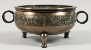 A CHINESE ARCHAIC BRONZE TRIPOD CENSER, with twin handles, the censer with a band of engraved