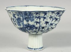 A CHINESE BLUE AND WHITE PORCELAIN STEM CUP, painted with plum blossom, bamboo and other flora,