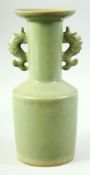 A CHINESE LONGQUAN STYLE CELADON TWIN HANDLE VASE, the handles formed as fish, 26cm high.