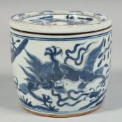 A CHINESE BLUE AND WHITE PORCELAIN CRICKET JAR painted with dragons and native flora, the base