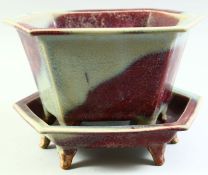 A CHINESE JUN WARE HEXAGONAL POTTERY PLANTER AND TRAY, the planter with pierced base and raised on