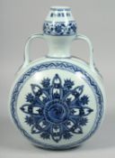 A CHINESE BLUE AND WHITE PORCELAIN TWIN-HANDLED MOON FLASK, the central decorative motif with yin-