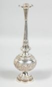 A LARGE INDIAN SILVER ROSEWATER SPRINKLER, the body with embossed floral decoration, the sprinkler
