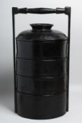 A CHINESE BLACK LACQUERED FOOD CARRIER, containing three detachable trays and lid, overall 44cm