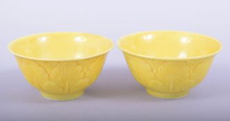 A PAIR OF CHINESE YELLOW GLAZED PORCELAIN CUPS, each with six-character mark to base, 7.5cm