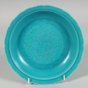 A CHINESE TURQUOISE GLAZE PETAL FORM DISH, the centre decorated with incised dragon and stylised