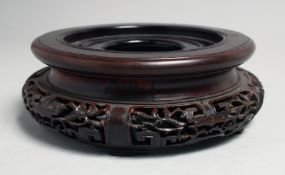 A CHINESE CARVED HARDWOOD CIRCULAR VASE STAND, to fit a base of 11.5cm diameter.