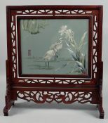 A LARGE CHINESE WOODEN TABLE SCREEN with embroidered panel depicting cranes, 49cm wide, 54.5cm