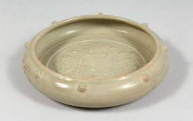 A CHINESE CELADON GLAZE CIRCULAR BRUSH WASHER, the interior with raised decoration depicting chilong