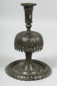 AN 18TH/19TH CENTURY PERSIAN QAJAR CANDLESTICK, 19cm high.
