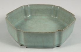 A CHINESE RU STYLE CELADON HEXAGONAL BRUSH WASHER, the base with incised calligraphy, 17.5cm at