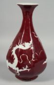 A CHINESE RED GROUND OCTAGONAL PORCELAIN VASE, decorated with incised dragon. 35.5cm high