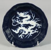 A CHINESE SACRIFICIAL BLUE GLAZE PORCELAIN PETAL FORM BOWL, the interior with incised dragon, 17.5cm