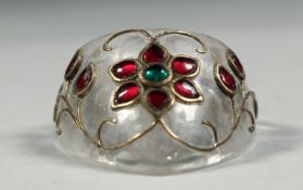 AN INDIAN MUGHAL ARCHER'S RING, onlaid with floral wire work and semi precious stones.