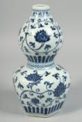 A CHINESE BLUE AND WHITE PORCELAIN DOUBLE GOURD VASE decorated with lotus and scrolling vine,