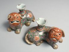 A PAIR OF 19TH CENTURY CHINESE CANTON FAMILLE ROSE PORCELAIN FOO DOG CANDLESTICK HOLDERS, the body