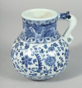 A CHINESE BLUE AND WHITE PORCELAIN JUG, decorated with lotus and other flora with scrolling vine,