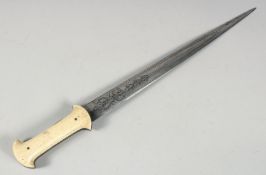 A FINE LARGE 18TH CENTURY OTTOMAN WALRUS HILTED DAGGER, with engraved steel blade, 49cm long.