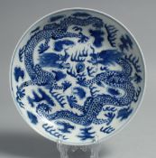 A CHINESE BLUE AND WHITE PORCELAIN DISH, painted with dragons and the flaming pearl of wisdom, six-