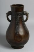 A CHINESE TWIN-HANDLED BRONZE VASE in the archaic style, with nine-character mark to base, 29cm