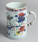 A CHINESE FAMILLE ROSE PORCELAIN TANKARD painted with floral sprays and exotic bird. 14.5cm high