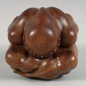 A CHINESE HARDWOOD CARVING OF A HUNCHED FIGURE, his head in his hands with sorrow, 12cm high.