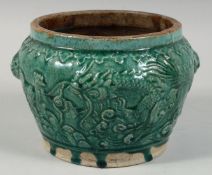 A CHINESE GREEN GLAZED POTTERY PLANTER, with raised decoration depicting a dragon and cockerel, 16.