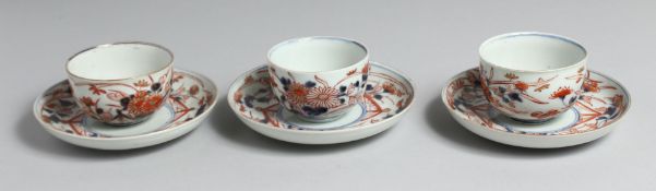 A SET OF THREE JAPANESE IMARI PORCELAIN CUPS AND SAUCERS, each with floral decoration. Plates 14.5cm