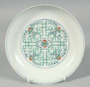 A CHINESE FAMILLE VERTE PORCELAIN DISH, the centre decorated with peach blossom motif, the base with