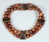 AN ANTIQUE RHINO HORN BEADED NECKLACE.**Please note: this item can only be sold within the UK**