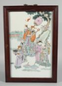 A CHINESE FAMILLE ROSE PORCELAIN PANEL IN A HARDWOOD FRAME, the panel painted with a dignitary and