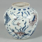 A CHINESE BLUE, WHITE AND UNDER-GLAZE RED PORCELAIN JAR, decorated with aquatic flora and fauna, the