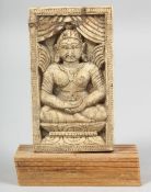 A 18TH/19TH CENTURY THAI CARVED BONE PLAQUE, depicting seated buddha, mounted to a wooden base,