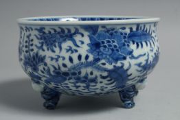 A JAPANESE BLUE AND WHITE PORCELAIN FOOTED BOWL, the exterior with foliate decoration, bowl