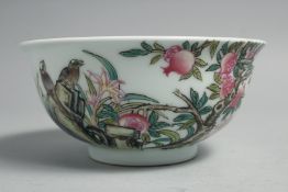 A CHINESE FAMILLE ROSE PORCELAIN BOWL, painted with pomegranate blossom and birds, the base with